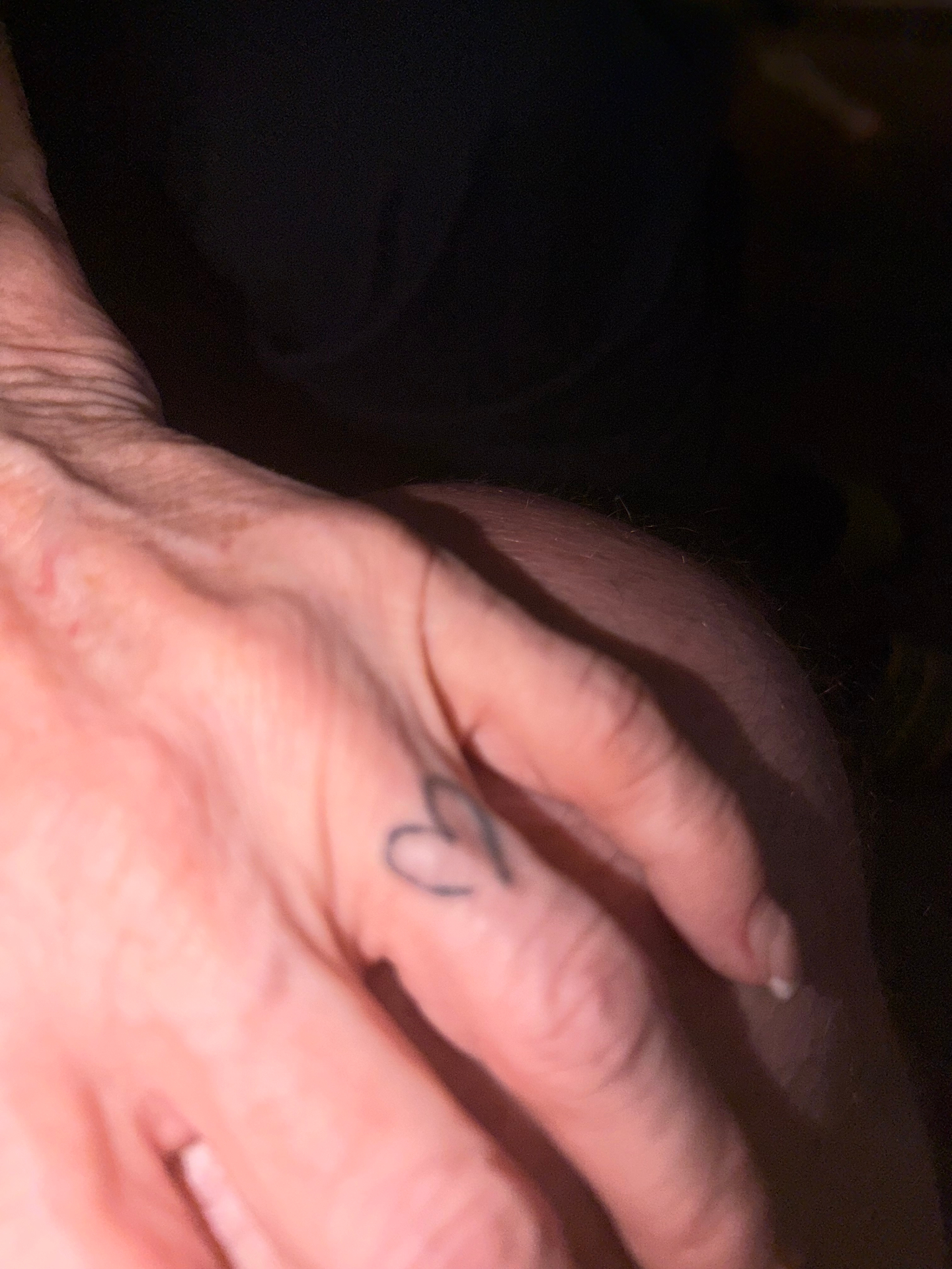 Her ring finger — heart tattoo